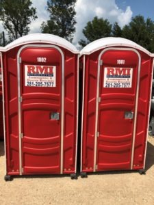 two-red-portable-restrooms