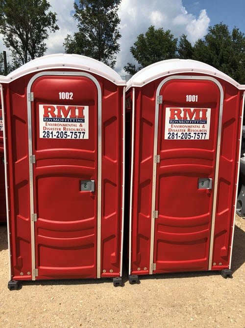 Two red portable restrooms